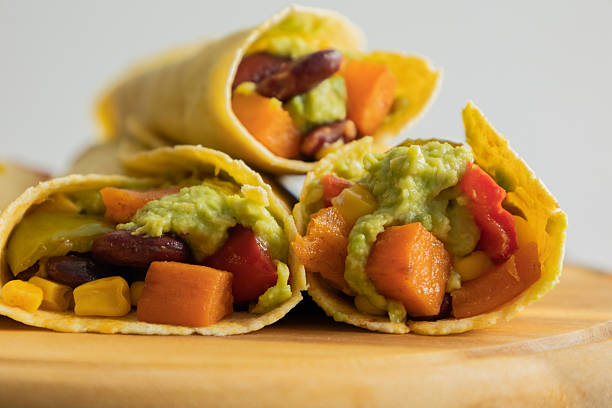 Corn Tortilla Tacos with Sweet Potato, Beans, Peppers and Smashed Avocado