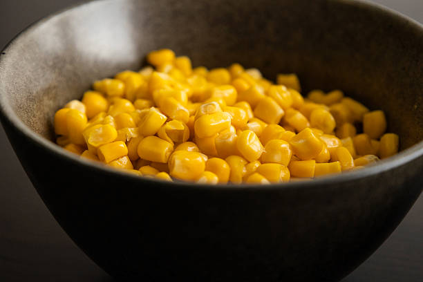 istock Drained Sweet Corn Kernels in Dark Bowl on Black Background Close-Up 2238109914