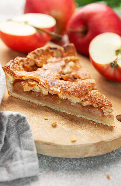 istock Apple pie slice on wooden board with apples 2238111113