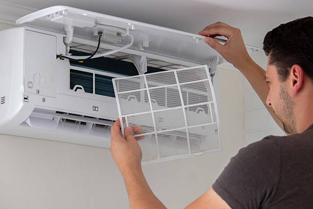 istock Maintenance Complete. Technician Installing Clean Air Filter in Air Conditioner 2238111258