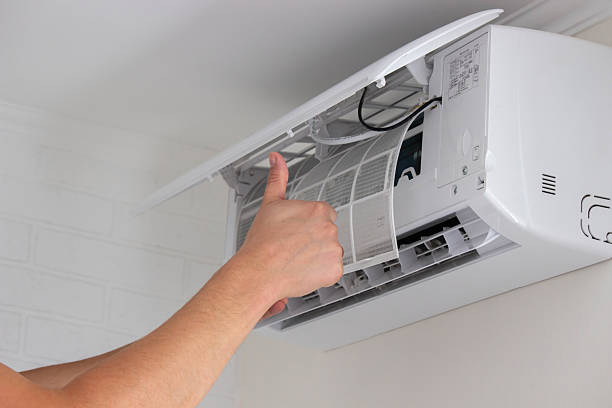 istock Maintenance Complete. Technician Installing Clean Air Filter in Air Conditioner 2238111274