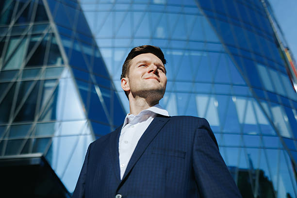 istock Ambitious young executive in sharp suit smiling proudly in modern city setting 2238111416