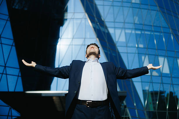 istock Confident young businessman with arms raised celebrating success 2238111446