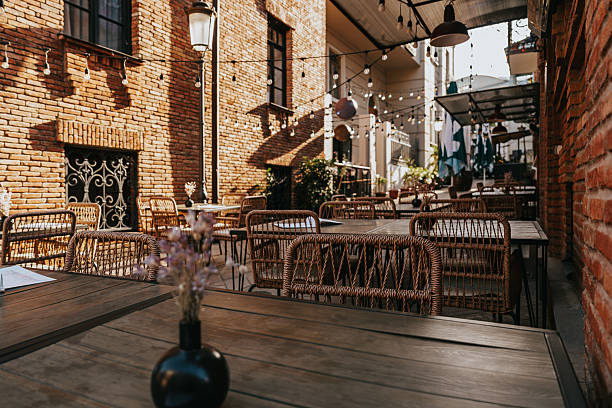istock Outdoor dining space in a cozy courtyard featuring rustic decor and beautiful lighting in the early evening 2238111773