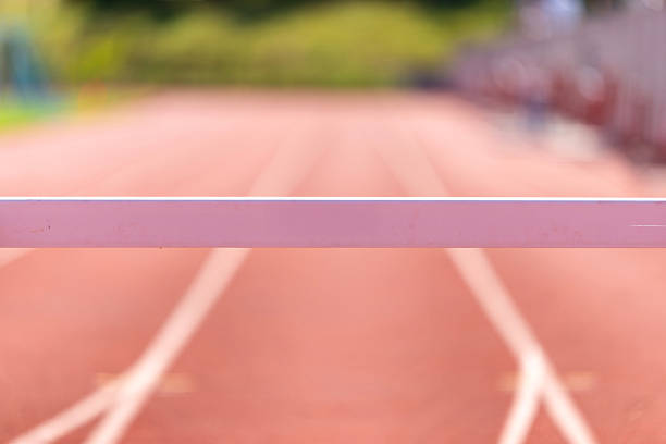Athlete Jumps Over Hurdles During a Track Hurlde Rac3e