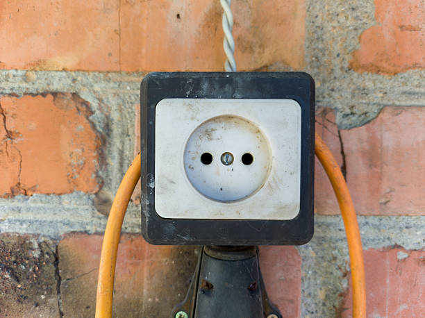 istock An electrical outlet on a brick wall with a yellow cord 2238112482