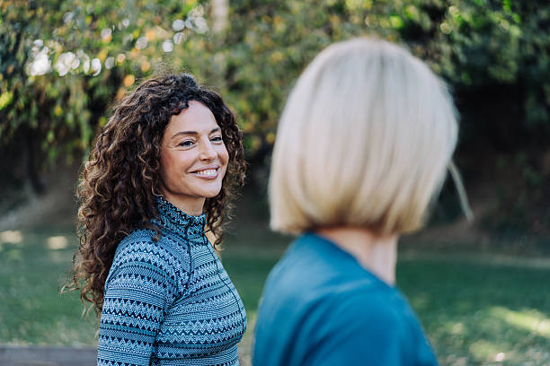 istock Friends talking and running in the public park. 2238112987