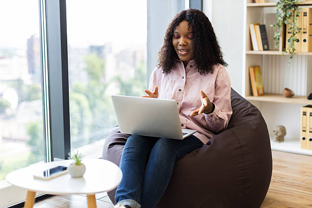 istock Woman having a video call while seated on a modern bean bag. 2238114401