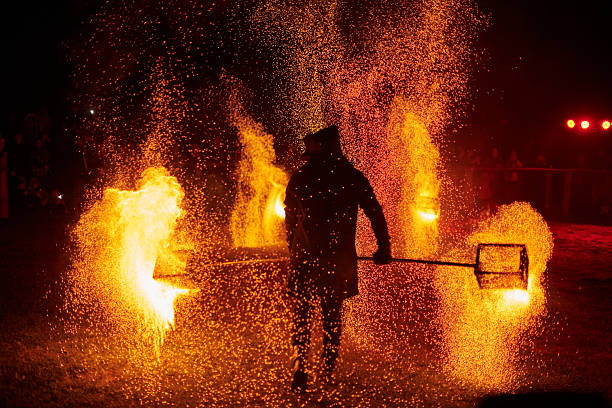 istock Silhouette of Two Fire Performers Creating Sparks Against Night field 2238114546
