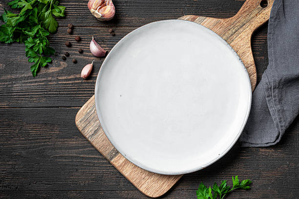 istock Empty white plate with herbs and garlic on wooden background 2238114777