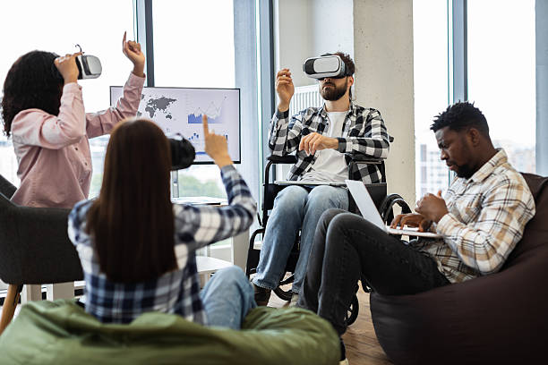 istock Group of diverse people using virtual reality glasses and laptops in office. 2238115506
