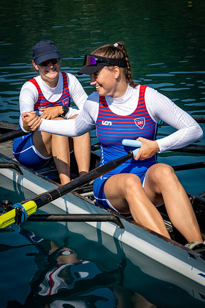 istock Two Women Rowing in Double Scull on Serene Lake 2238115837