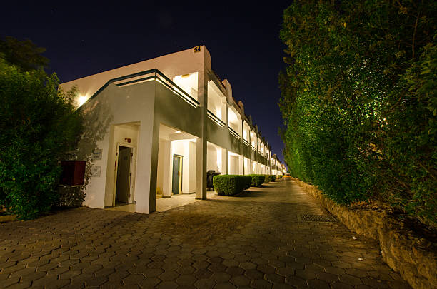 istock Nighttime facade of modern hotel with illuminated pathway 2238117172