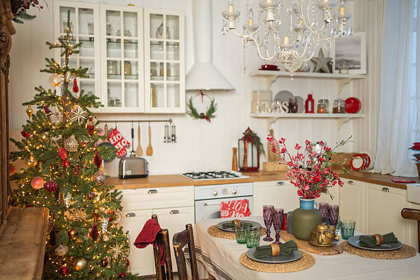 istock Classical Christmas decorated interior kitchen. Modern classic style interior design apartment dining room and Christmas tree with red golden ornament decorations. Christmas eve at home. 2238117377
