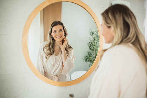 istock Mature woman applying moisturizer on face 2238117994
