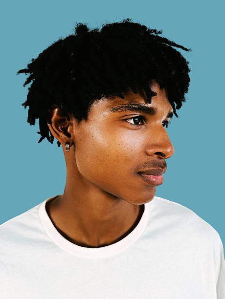 istock Thoughtful Black Male Portrait with Natural Lighting on Blue Background Side Profile 2238118743