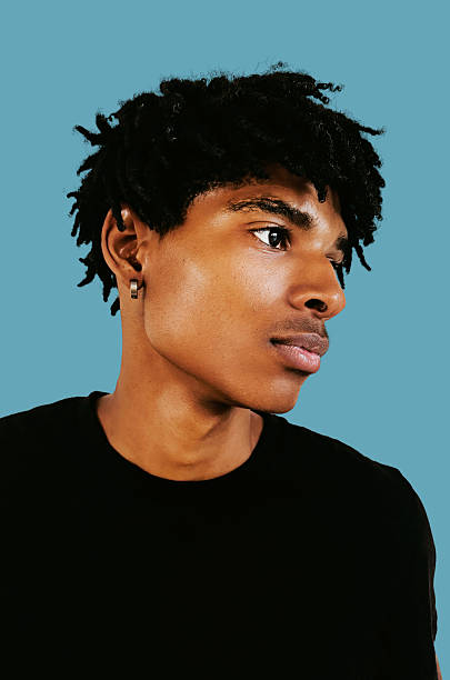 istock Thoughtful young Black man portrait with natural light against solid blue background 2238118754