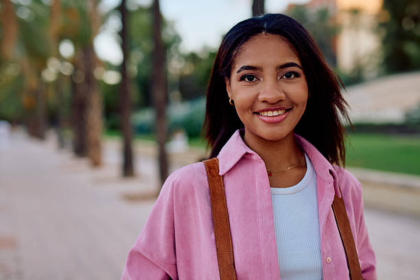 istock Young woman smiling outdoors in a park 2238118836