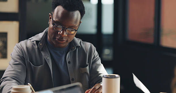 istock Coffee shop, freelance and black man on tech for working on online report, article and research. Creative, remote worker and person on computer for copywriting, editing news and website in cafe 2238119045