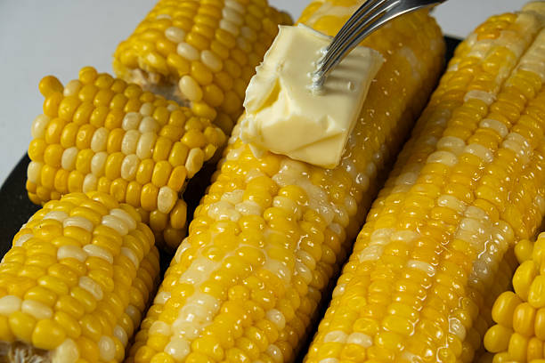 istock Hot Corn Cobs Covered with Creamy Butter Spread. 2238119145