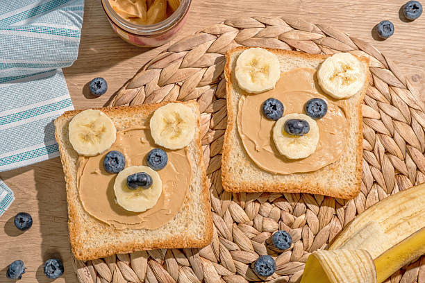 istock Two slices of bread with peanut butter and bananas on them 2238119293