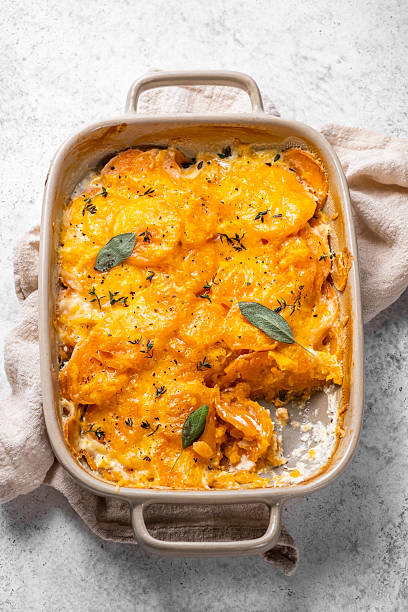 istock A casserole dish filled with orange potatoes and cheese 2238119299