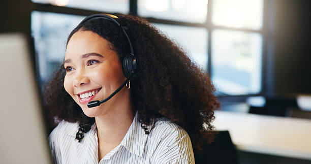 istock Customer service, call center consultant and happy woman on computer for multilingual support. Contact us, headset and African agent talk for language translation, communication and help with crm 2238119455