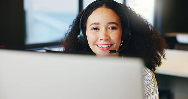 istock Smile, call center agent and woman on computer for multilingual support, help and crm. Contact us, tech and happy African consultant talk for language translation, interpretation or customer service 2238119460