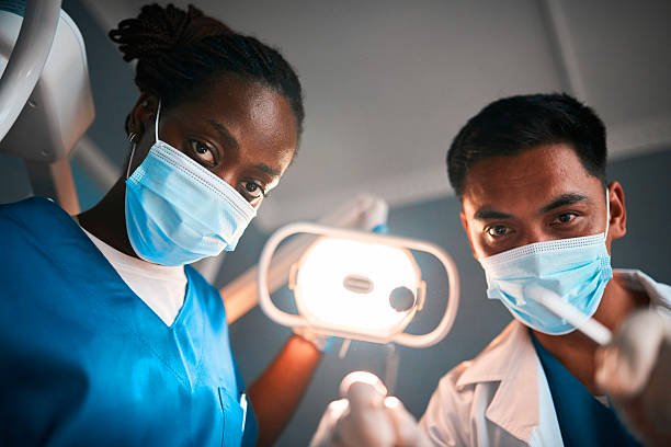 istock Two Dentists In Masked Dentistry Practice Demonstrating Tools And Collaboration 2238120229