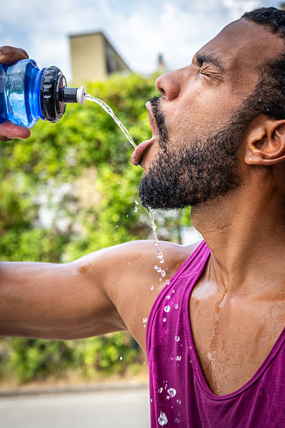 istock African American Athlete Hydrating Outdoors with Water Bottle 2238120261