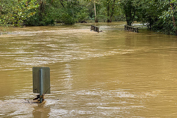 A normally small river has flowed far beyond its banks after record breaking rainfall causing flash floods in the area.