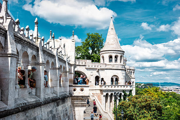 Tourists visit the Fisherman's Bastion in Budapest, Hungary, on a sunny day.