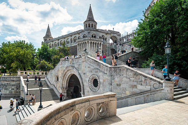 Tourists visit the Fisherman's Bastion in Budapest, Hungary, on a sunny day.