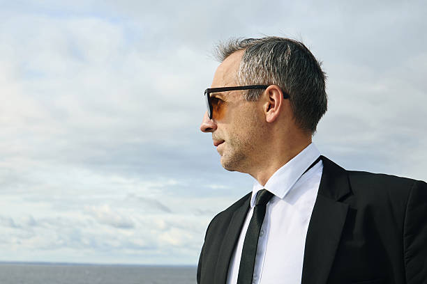 Smiling businessman standing outdoorshttp://www.twodozendesign.info/i/1.png