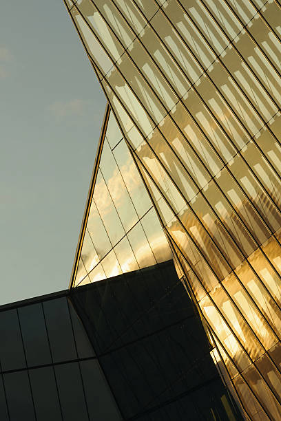 istock Modern Glass Skyscraper Reflecting Sunlight during Golden Hour in Cityscape 2238125785