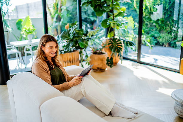 istock European senior woman using digital tablet at home 2238129203