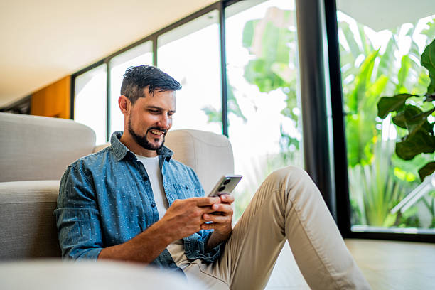 istock Australian mid adult man using mobile phone at home 2238129516