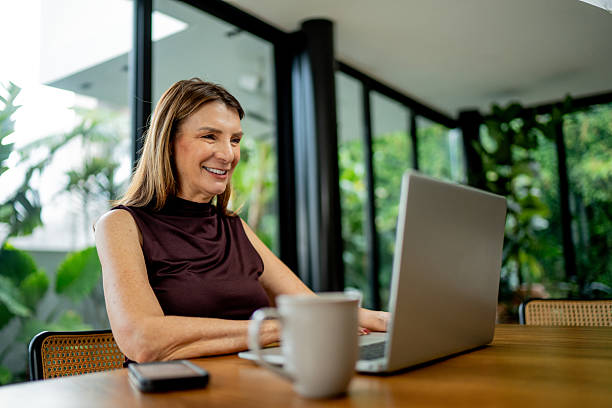 istock European senior woman using laptop at home 2238130962