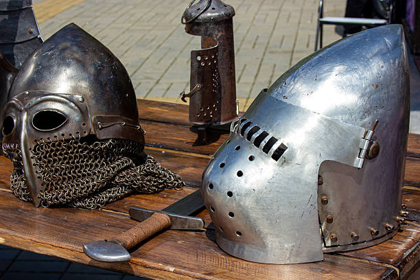 istock Knight's helmets made of iron on a wooden surface 2238131948