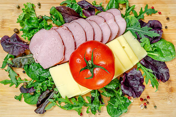Charcuterie luxury. A perfect holiday appetizer plate, made from variety of ham and cheese delicatessen, dry beef ham, dry pork sausage, Camembert cheese, Gauda cheese, organic olives, dry figs, cherry tomato, rosemary, fresh olive oil, local organic seasoning, herbs and spices. Representing a healthy lifestyle, healthy eating, a wellbeing, modern city life, traditional culture and a perfect brunch gourmet delicatessen.
