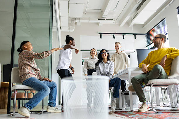 istock Colleagues relaxing together at work playing basketball - using paper balls and garbage bin 2238134739
