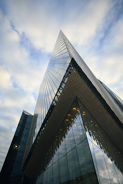 istock Modern Glass Skyscraper Reflecting Sky and Clouds in Urban Cityscape 2238138612
