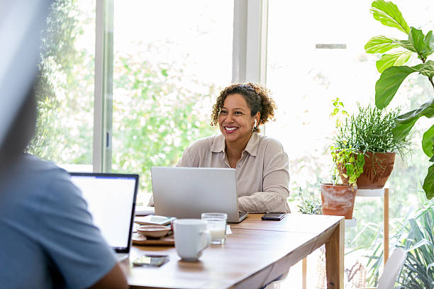 istock Diverse group of people collaborating and working remotely on laptops indoors, natural light. 2238138927