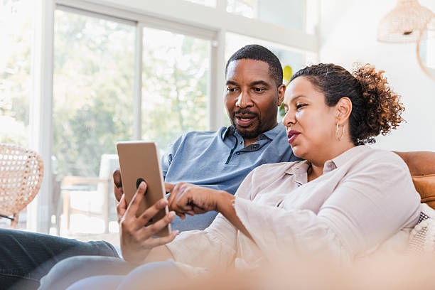 istock Couple Using A Tablet Together Indoors, Connected and Engaged in a Shared Activity 2238138935