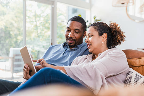 istock Couple using digital tablet for entertainment, communication, and learning together indoors. 2238138946