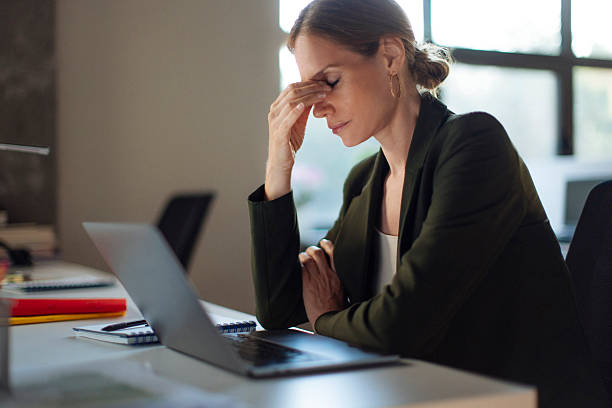 istock Businesswoman Feeling Stressed at Her Office Desk During Work Hours 2238139253