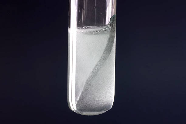 Laboratory flask with a tungsten plate in alkali