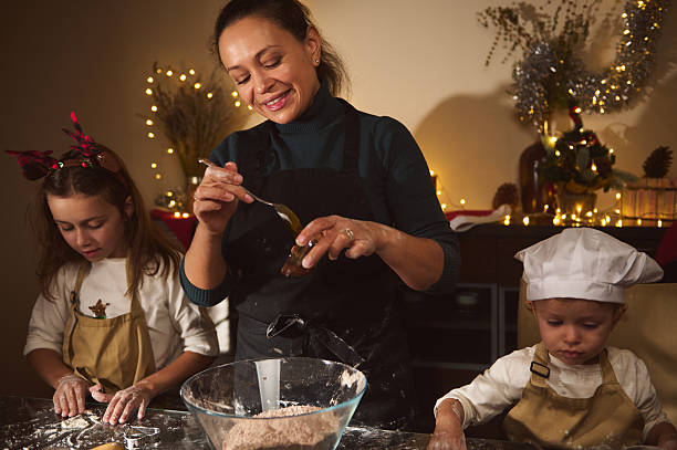 istock Joyful Mother Baking Gingerbread With Kids During Christmas At Home 2238141739