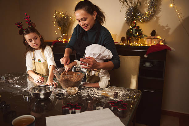 istock Joyful Mother Baking Gingerbread With Her Kids During Christmas Preparations At Home 2238141796