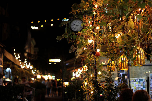istock Cozy evening cityscape with street lights and clock 2238146237